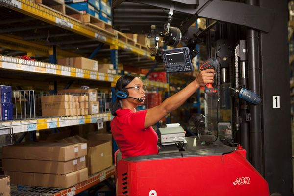 A warehouse worker uses honeywell mobile devices to scan barcodes for inventory management.